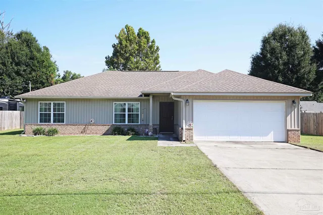 a front view of house with yard outdoor seating and barbeque oven