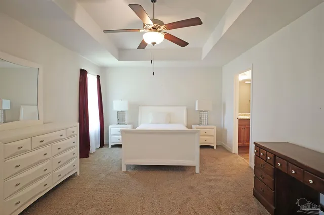 a living room with furniture and a dresser