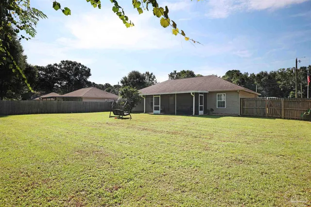 a house view with swimming pool in front of it