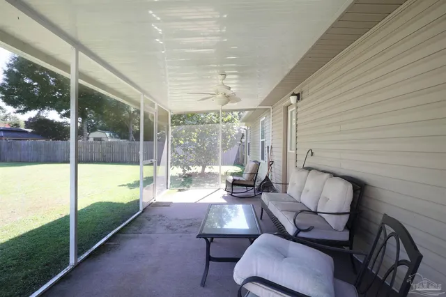 a balcony with chairs and table with wooden floor