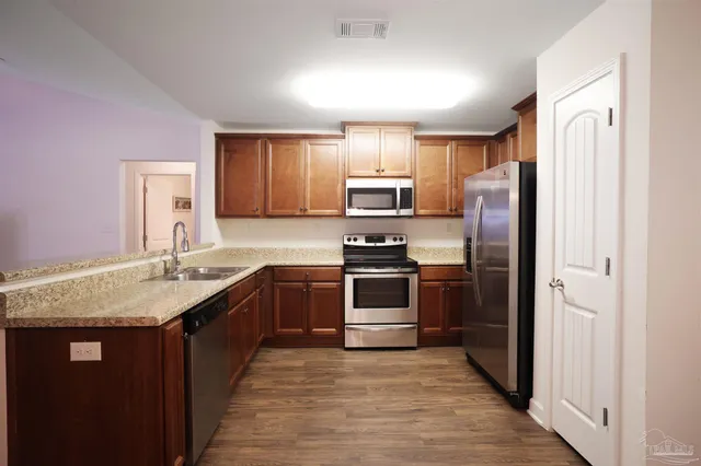 a kitchen with a sink stove and refrigerator