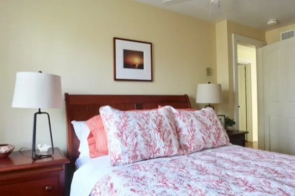 a bedroom with a bed and a lamp