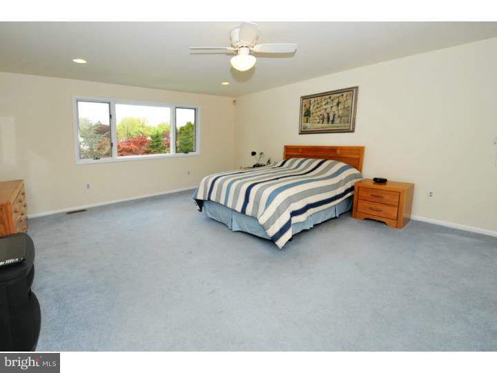 85 Kent Road Huntingdon Valley, PA 19006 - Photo 24 of 25 a spacious bedroom with a bed and a painting on the wall
