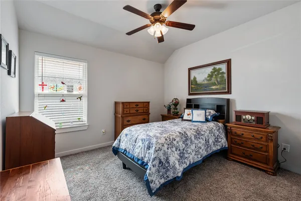 a bedroom with a bed dresser and a window