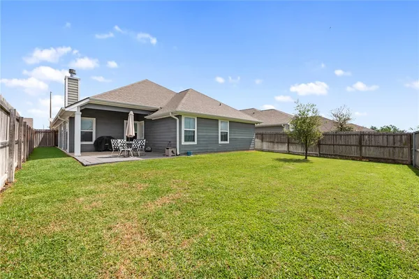 a view of a house with a backyard porch and sitting area