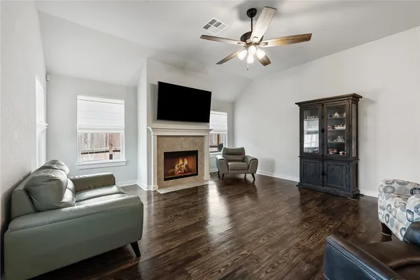 a living room with furniture a fireplace and a flat screen tv