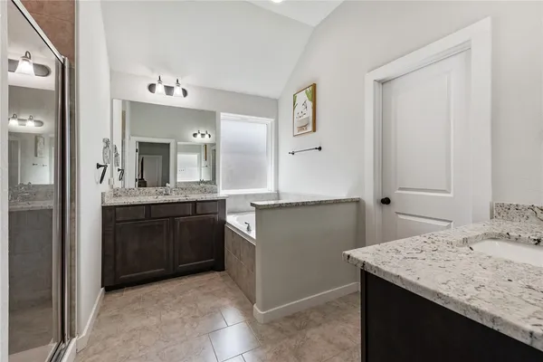 a bathroom with a granite countertop sink a mirror and a vanity