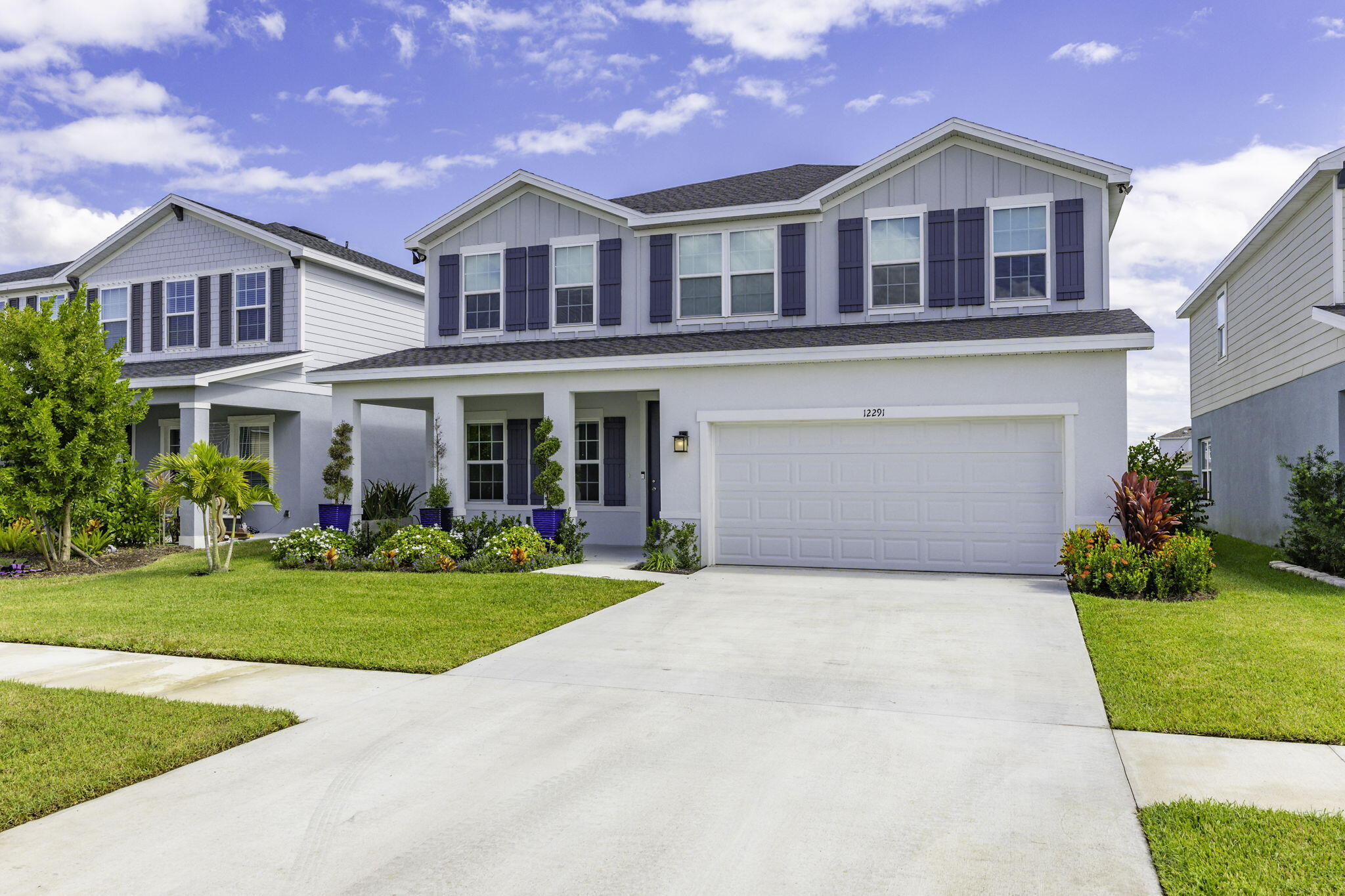 12291 Southwest Forli Way Port St. Lucie, FL 34987 - Photo 1 of 47 a front view of a house with a yard and garage