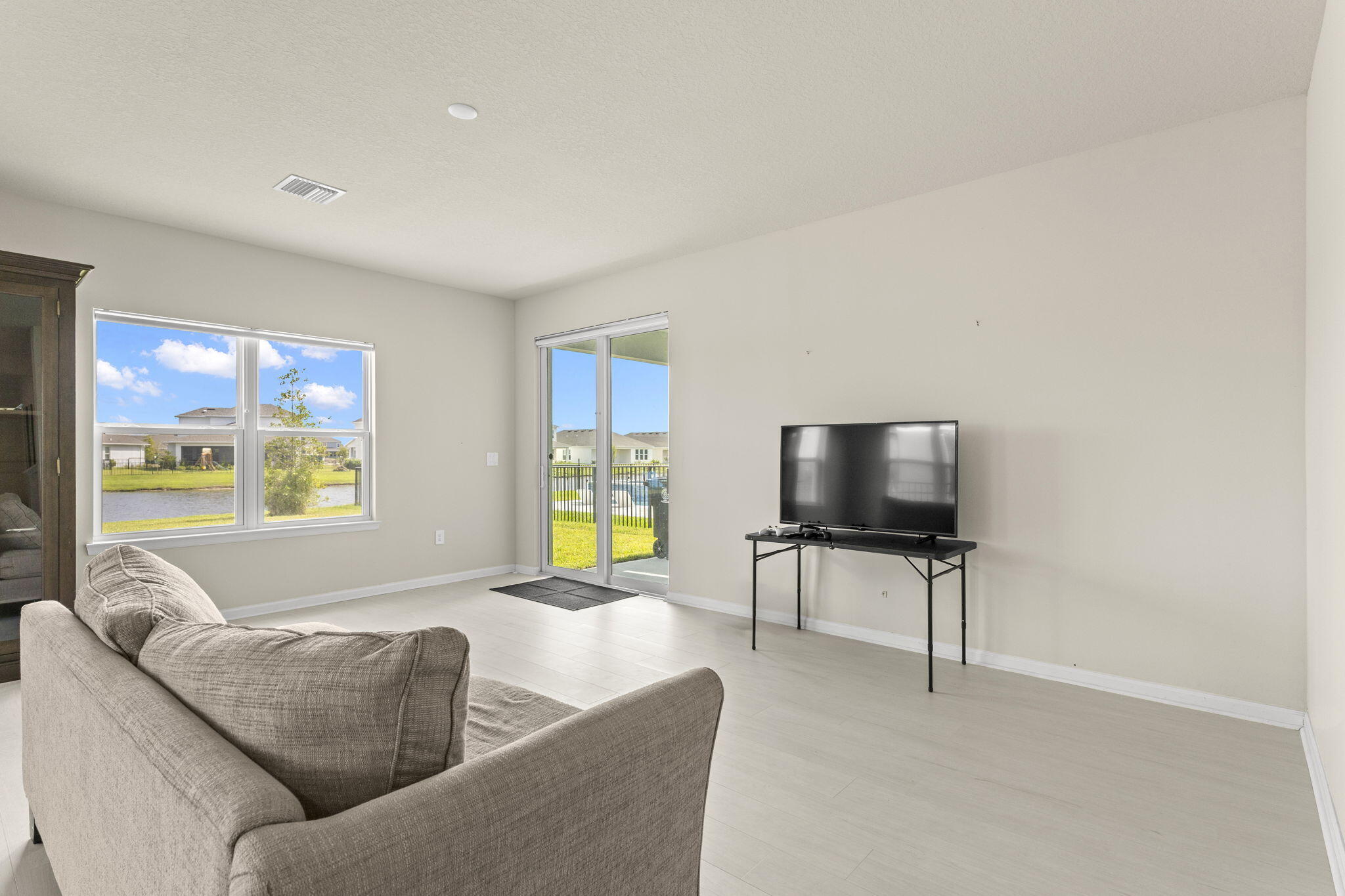 12291 Southwest Forli Way Port St. Lucie, FL 34987 - Photo 12 of 47 a living room with furniture and a flat screen tv