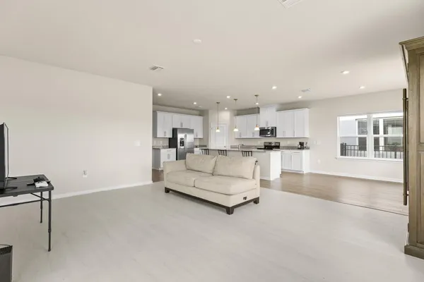 a living room with kitchen view and a view of kitchen