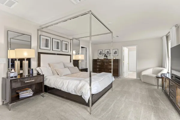 a bedroom with a bed and a lamp on table