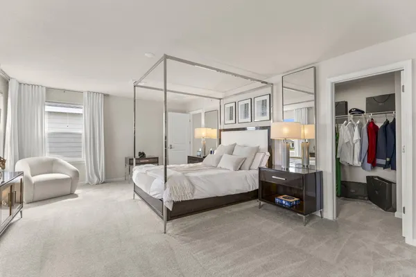 a spacious bedroom with a bed and a couch