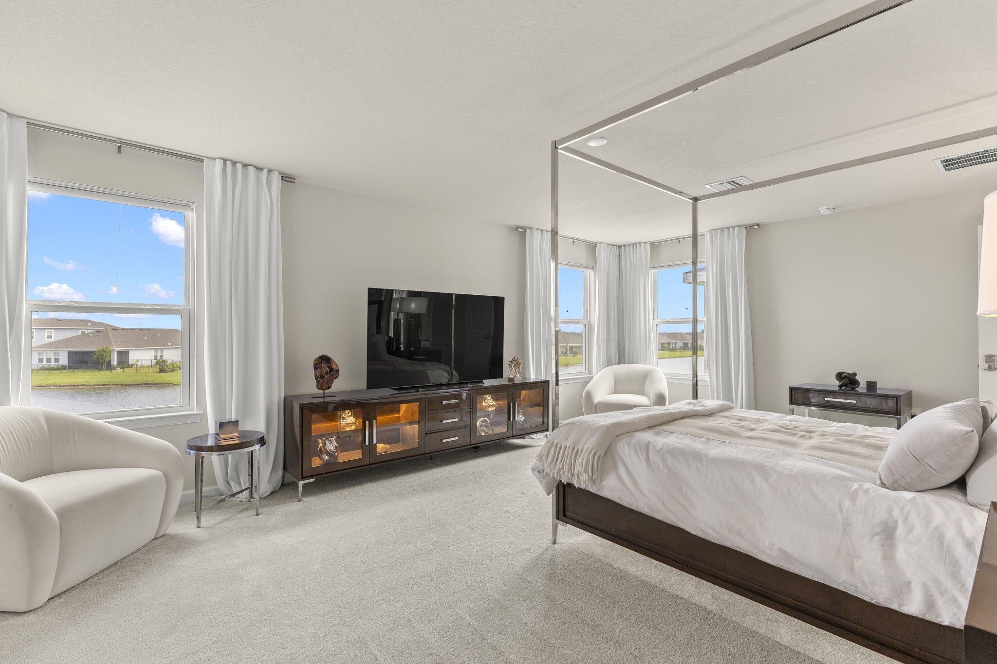 12291 Southwest Forli Way Port St. Lucie, FL 34987 - Photo 23 of 47 a bedroom with a bed and a flat tv screen on dresser