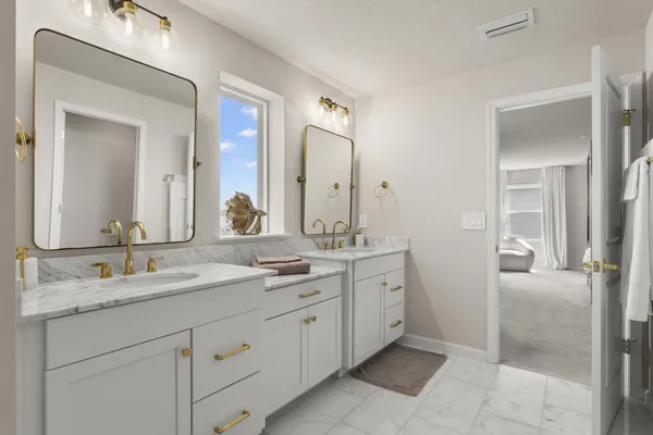a bathroom with a granite countertop sink mirror and double