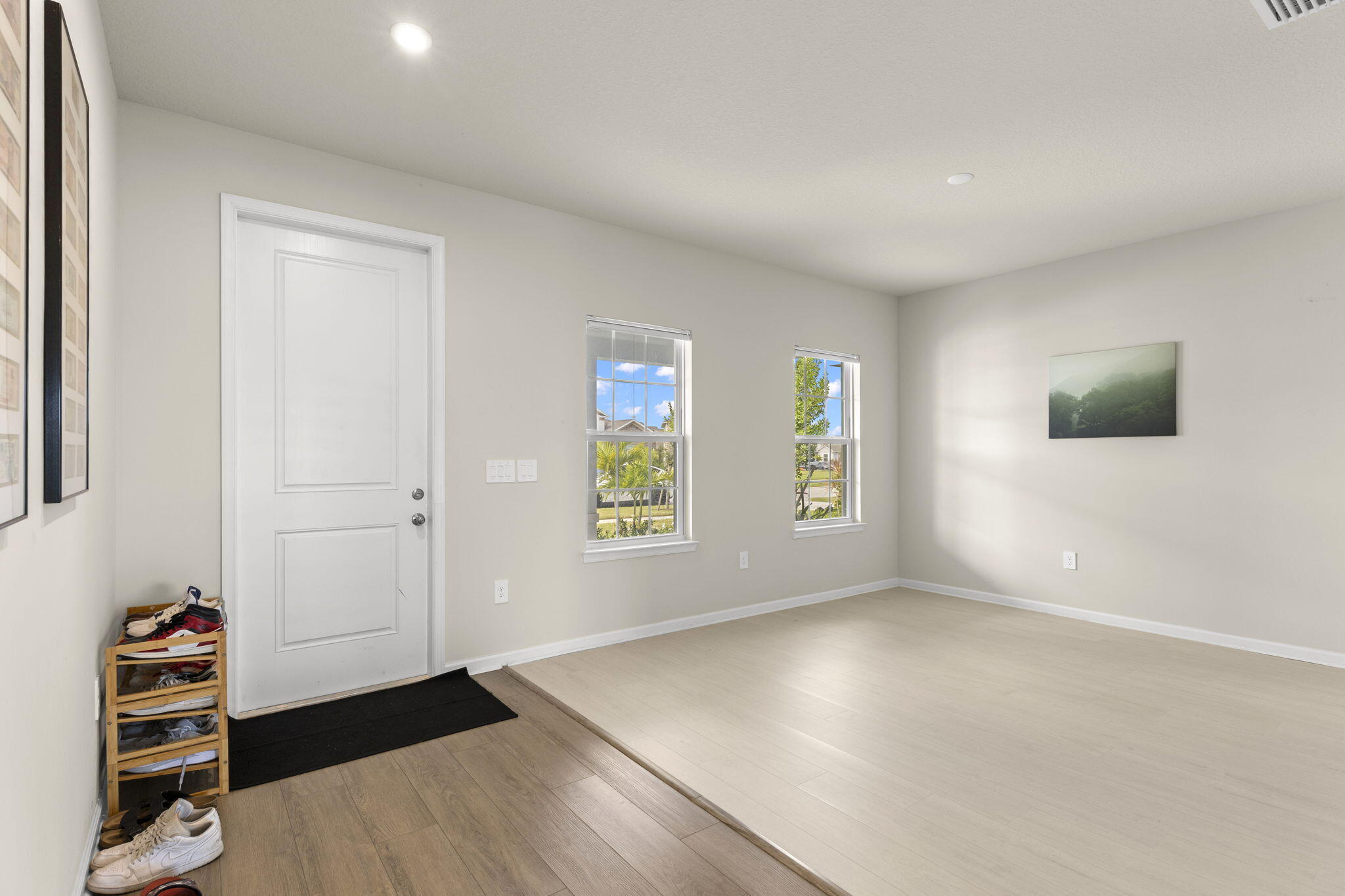 12291 Southwest Forli Way Port St. Lucie, FL 34987 - Photo 4 of 47 wooden floor in an empty room with a window