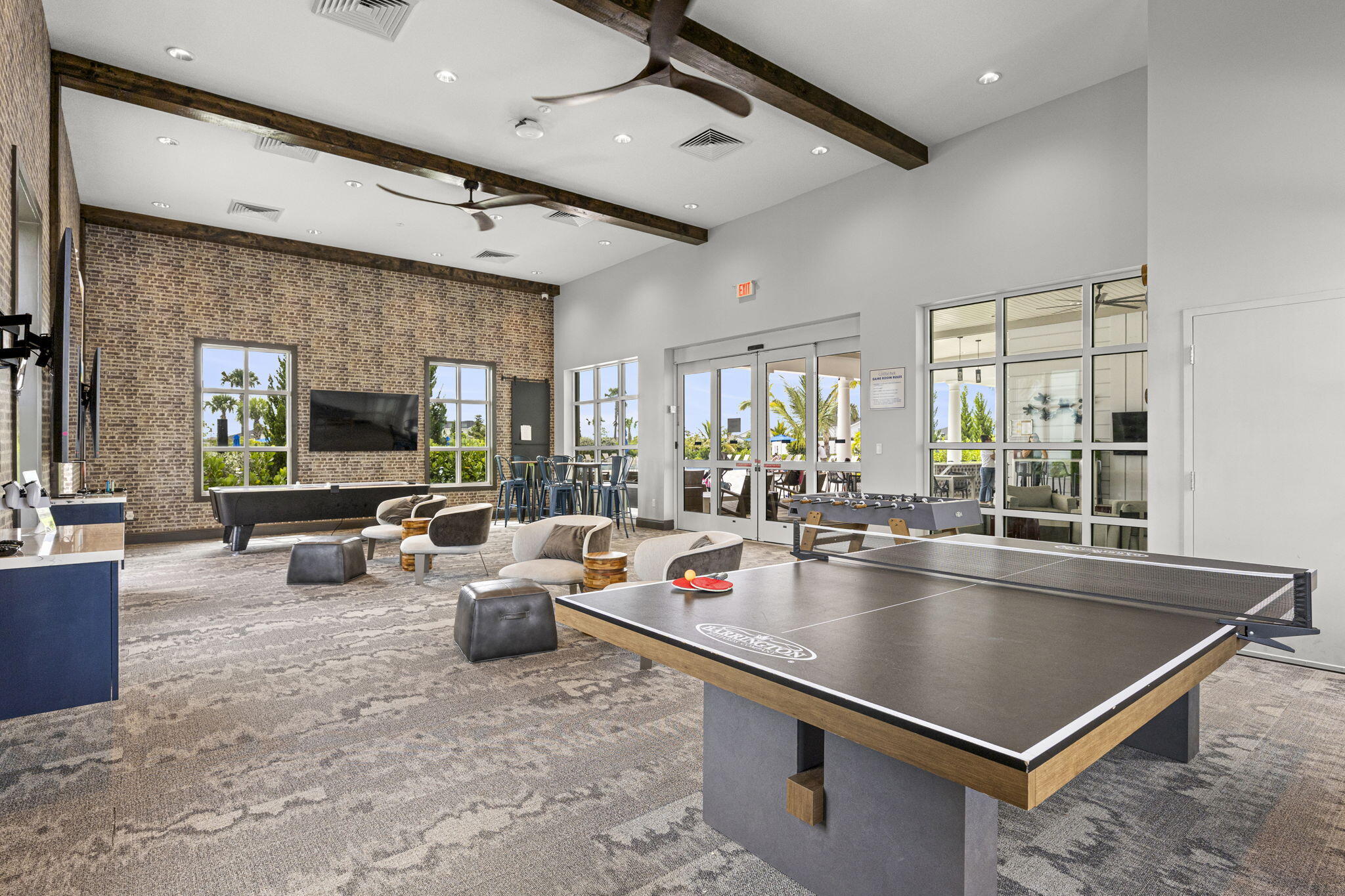 12291 Southwest Forli Way Port St. Lucie, FL 34987 - Photo 43 of 47 a living room with stainless steel appliances furniture a flat screen tv and a view of kitchen