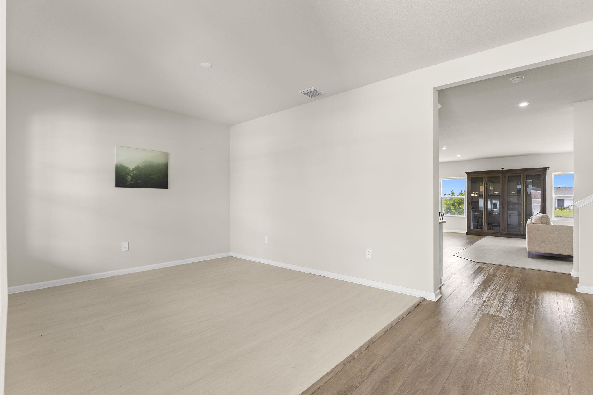12291 Southwest Forli Way Port St. Lucie, FL 34987 - Photo 5 of 47 a view of a living room hardwood floor and a kitchen