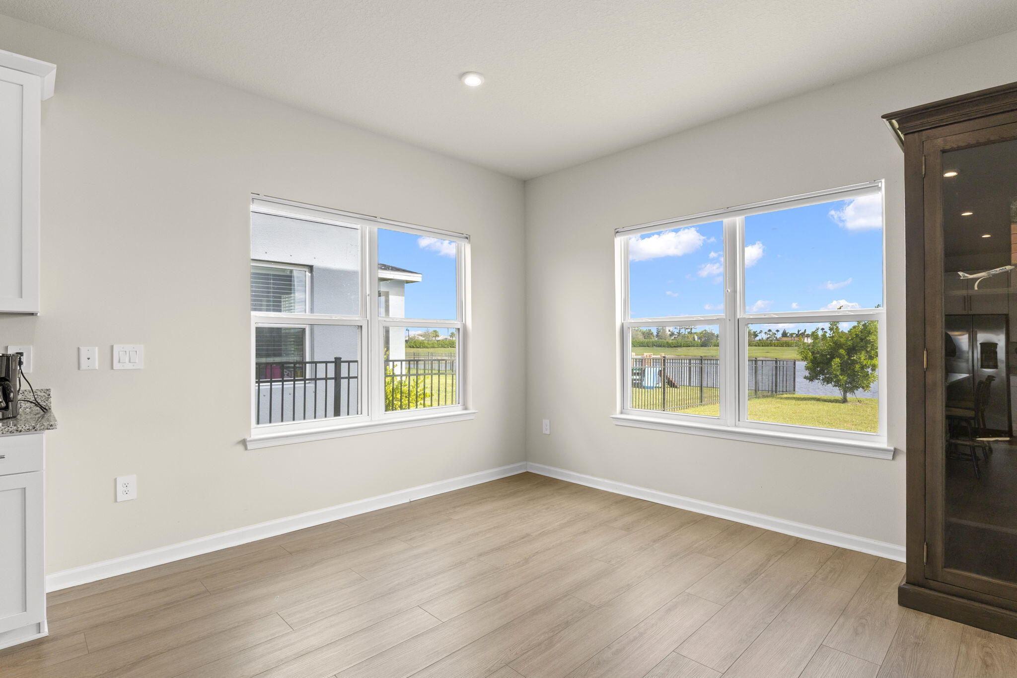 12291 Southwest Forli Way Port St. Lucie, FL 34987 - Photo 10 of 47 an empty room with wooden floor and windows