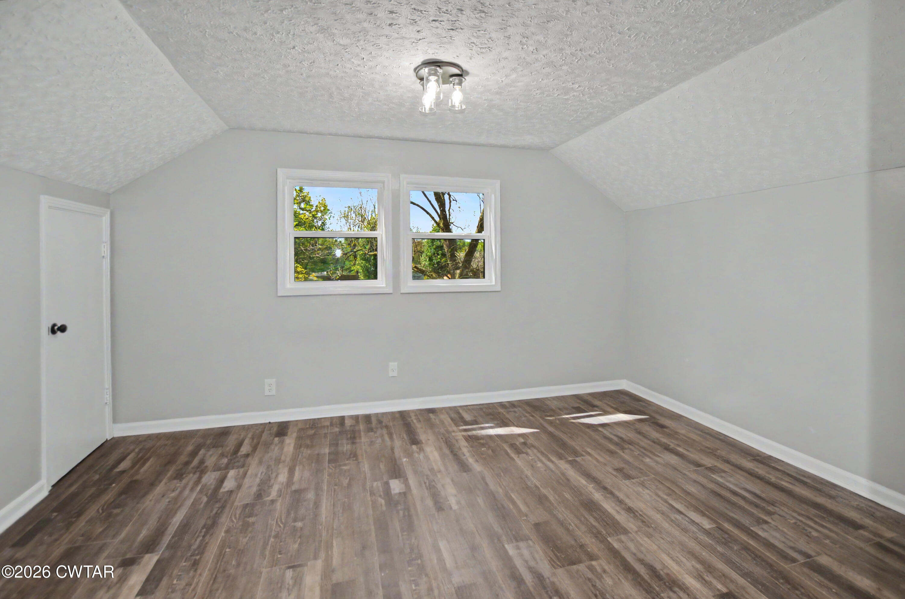 4177 Gum Flat Road Bells, TN 38006 - Photo 29 of 30 an empty room with wooden floor and windows
