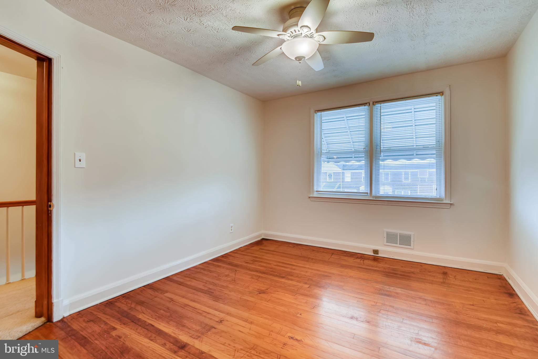 1951 Searles Road Baltimore, MD 21222 - Photo 14 of 28 Bedroom #1 with Ceiling Fan and Hardwoods