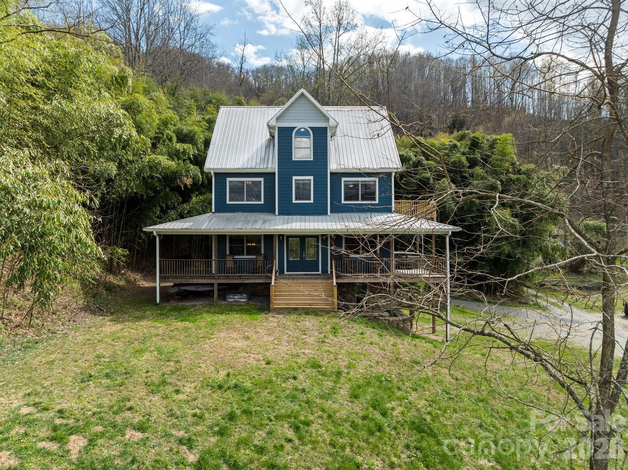 22 Pear Tree Lane Leicester, NC 28748 - Photo 1 of 47 a view of a house with a wooden deck and a trees