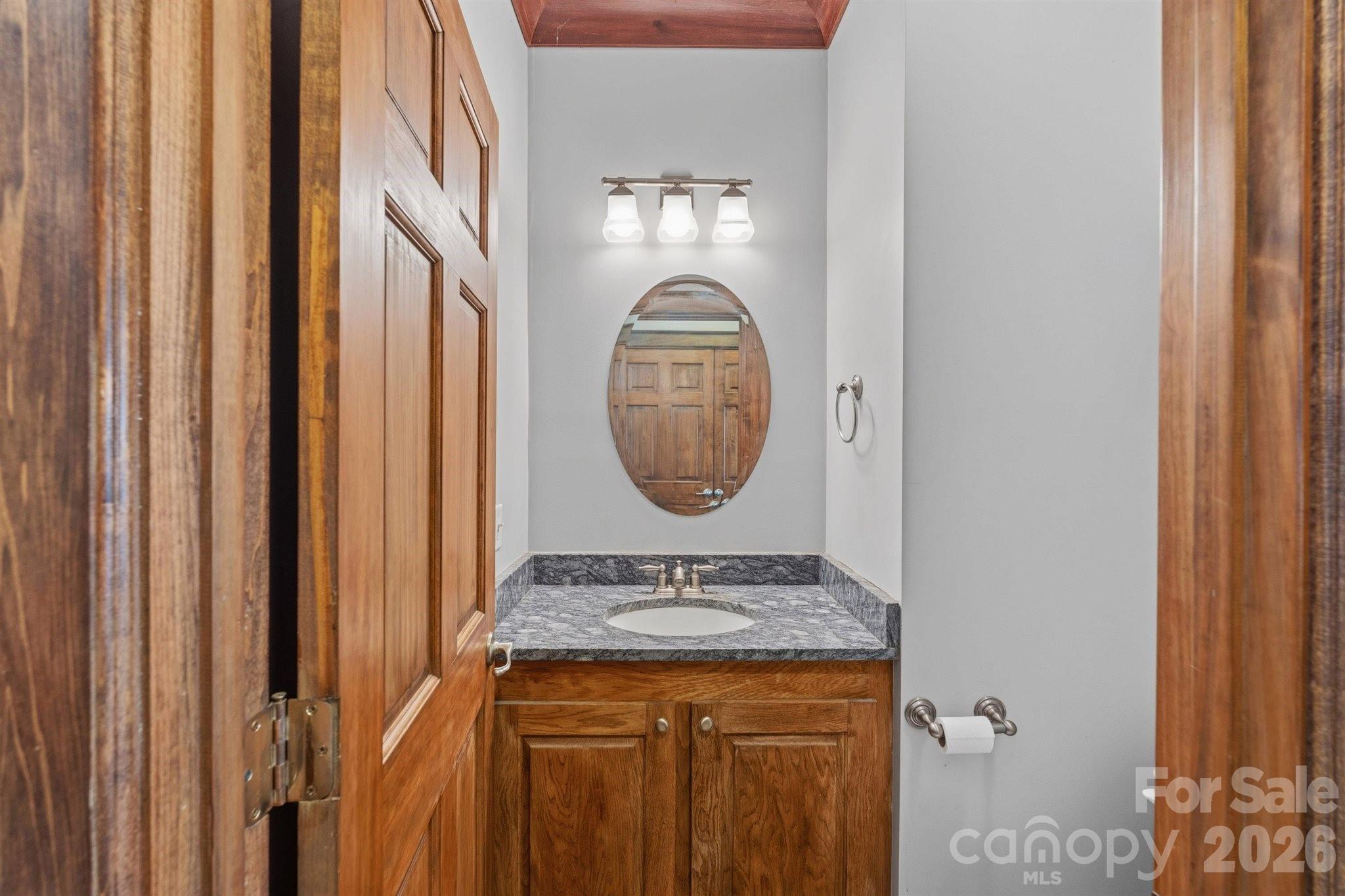 22 Pear Tree Lane Leicester, NC 28748 - Photo 13 of 47 a bathroom with a granite countertop sink and a mirror