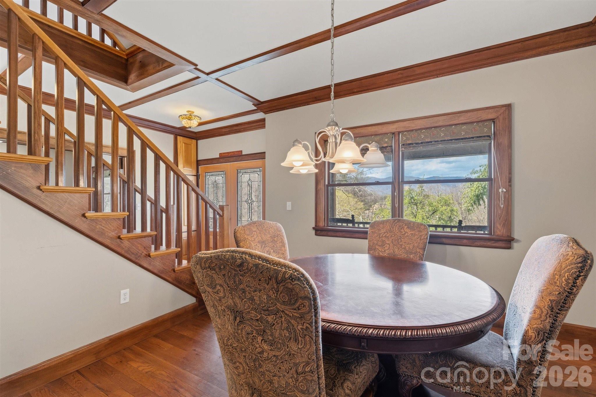 22 Pear Tree Lane Leicester, NC 28748 - Photo 14 of 47 a view of a dining room with furniture a chandelier and wooden floor