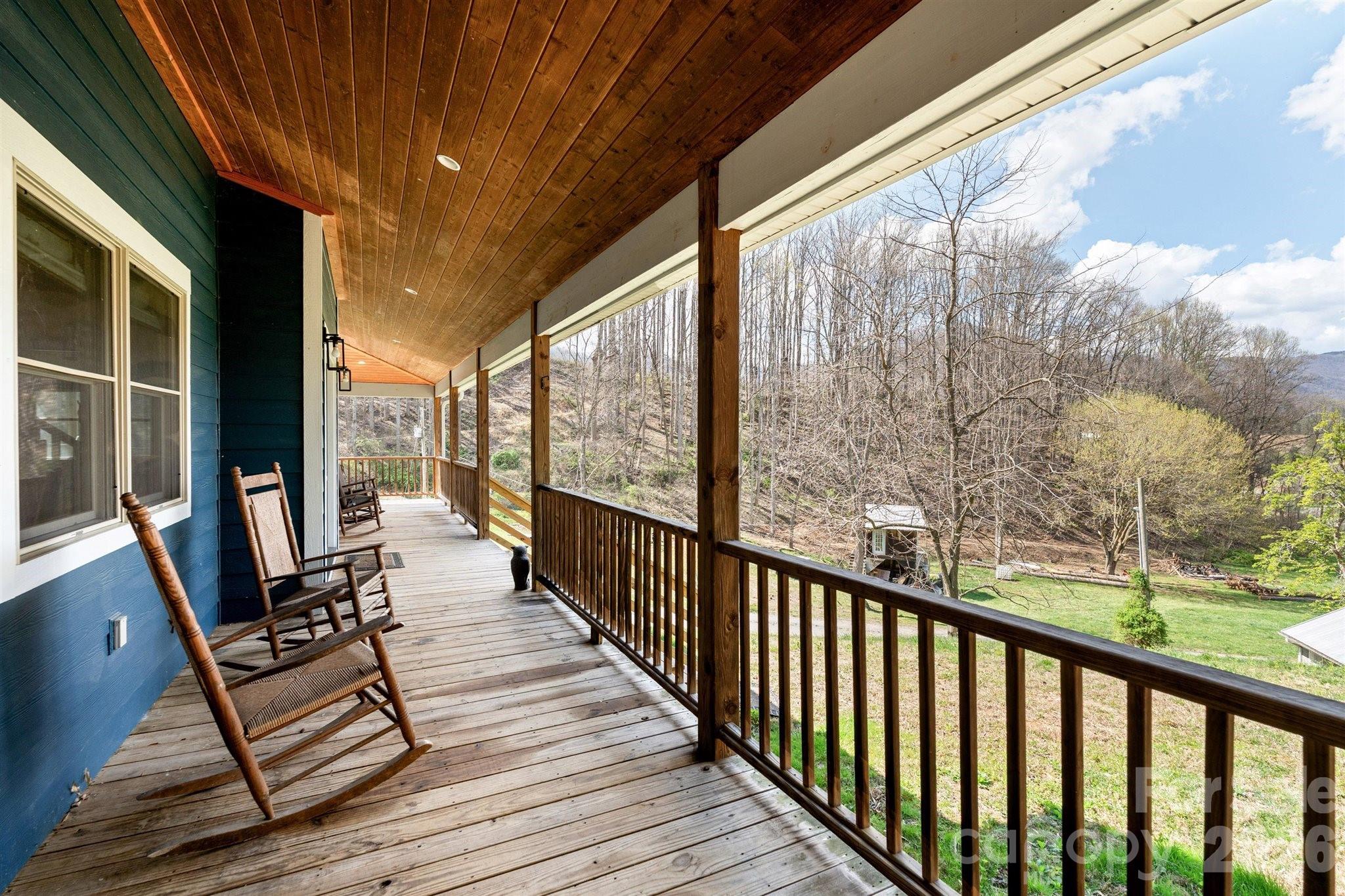 22 Pear Tree Lane Leicester, NC 28748 - Photo 35 of 47 a view of balcony with couch and wooden floor