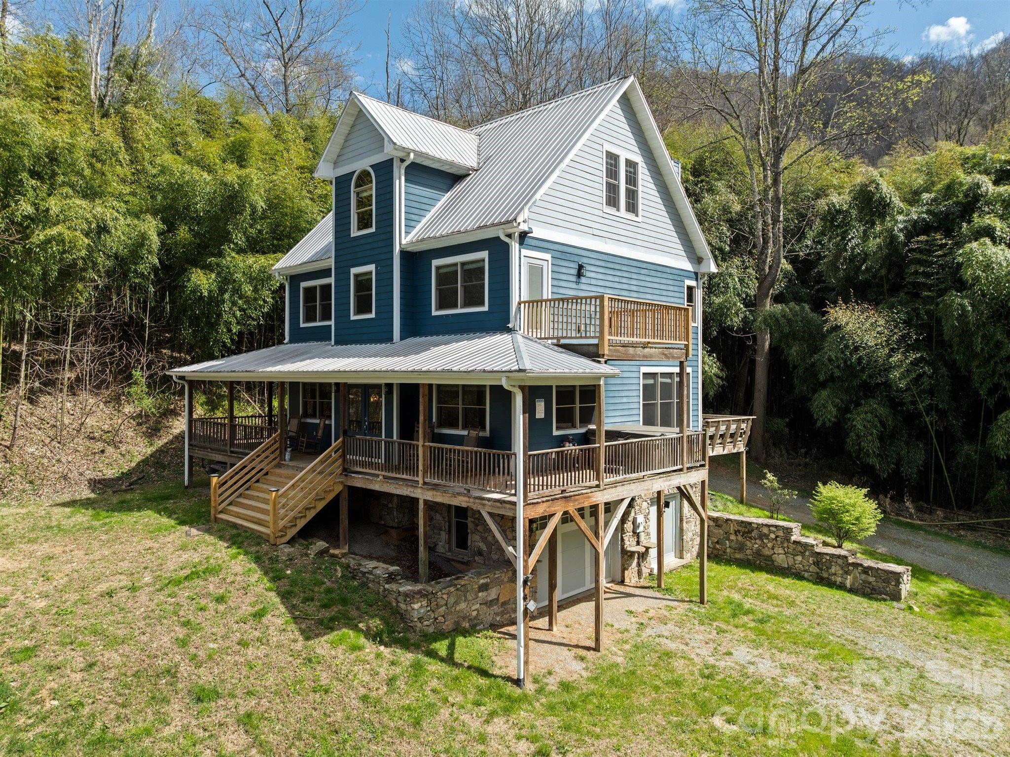 22 Pear Tree Lane Leicester, NC 28748 - Photo 45 of 47 a view of a house with backyard wooden fence and chairs