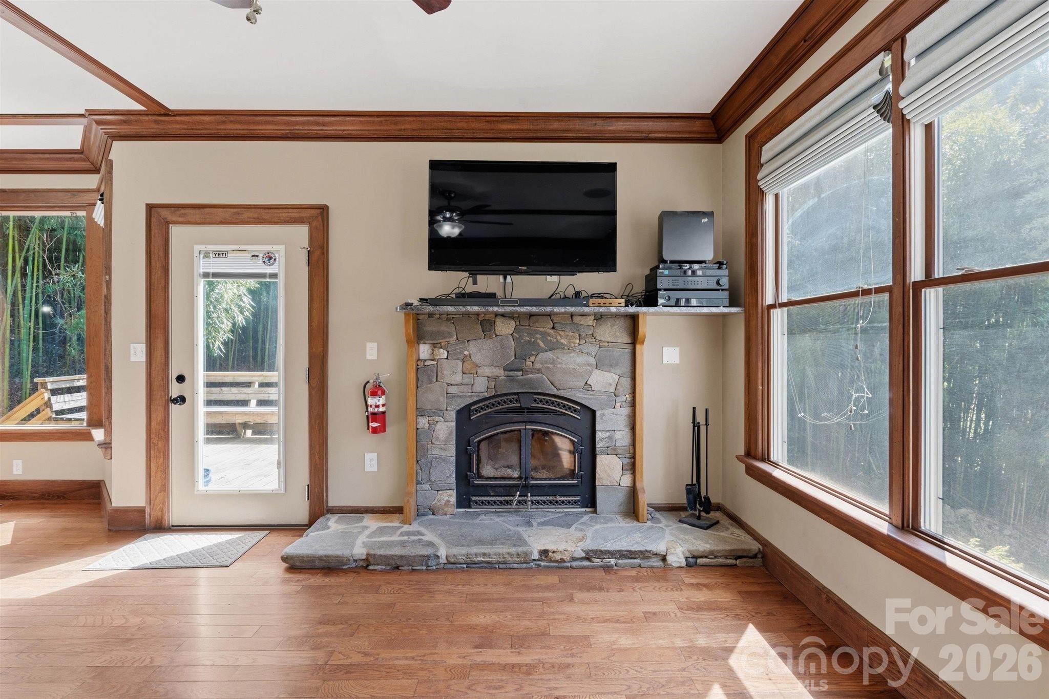 22 Pear Tree Lane Leicester, NC 28748 - Photo 6 of 47 a living room with a fireplace and a flat screen tv
