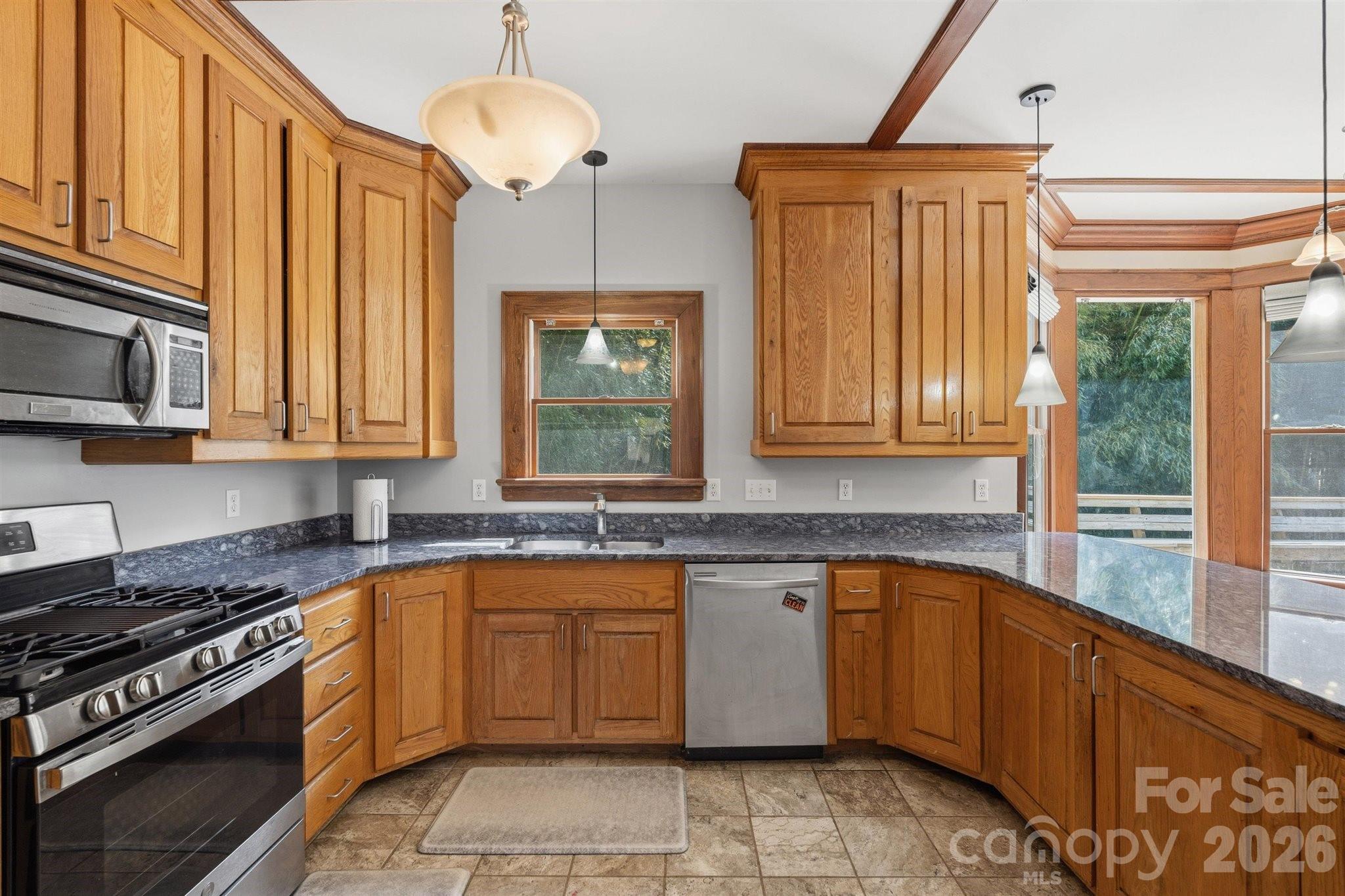 22 Pear Tree Lane Leicester, NC 28748 - Photo 10 of 47 a kitchen with a sink stove and microwave