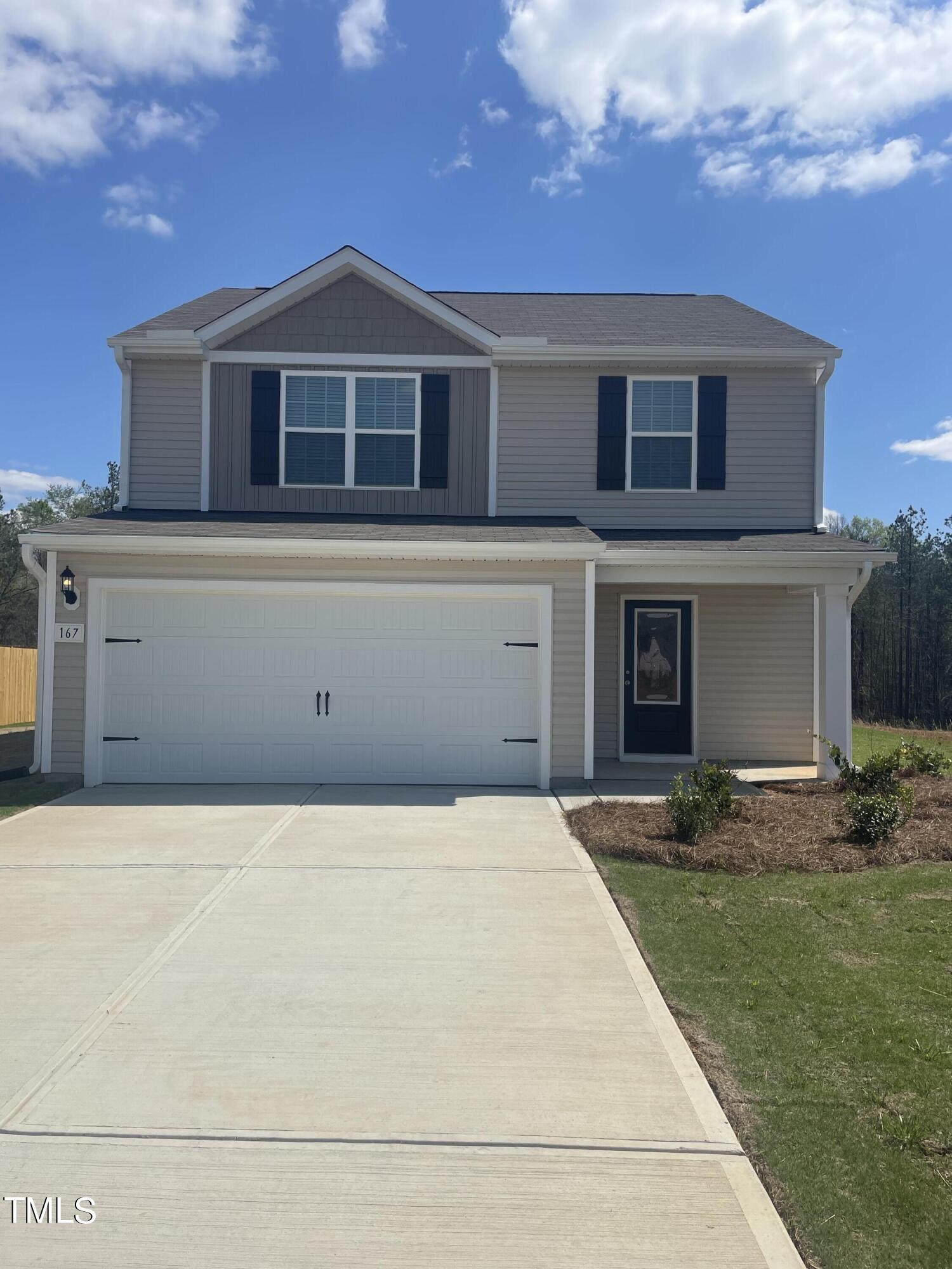 167 Crow Field Street Roxboro, NC 27574 - Photo 1 of 12 a front view of a house with a yard and garage