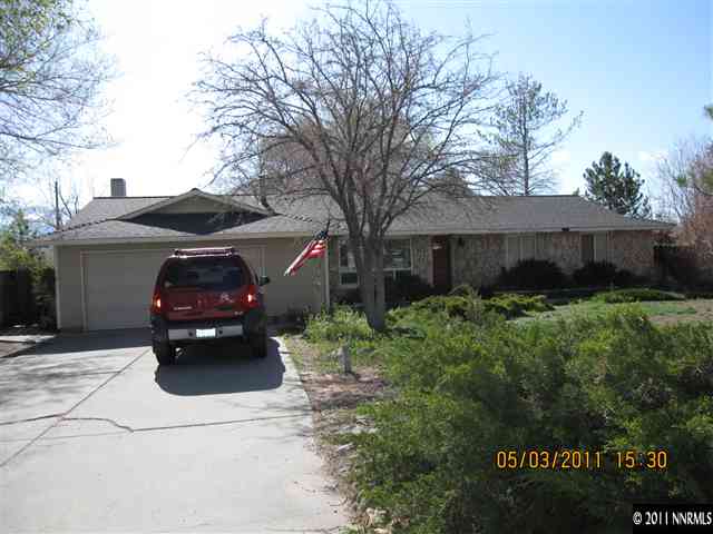 14595 Geronimo Trail Reno, NV 89521 - Photo 1 of 13 a front view of a house with a garden