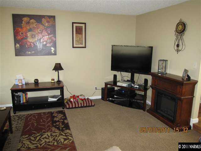 14595 Geronimo Trail Reno, NV 89521 - Photo 4 of 13 a bedroom with furniture and a flat screen tv