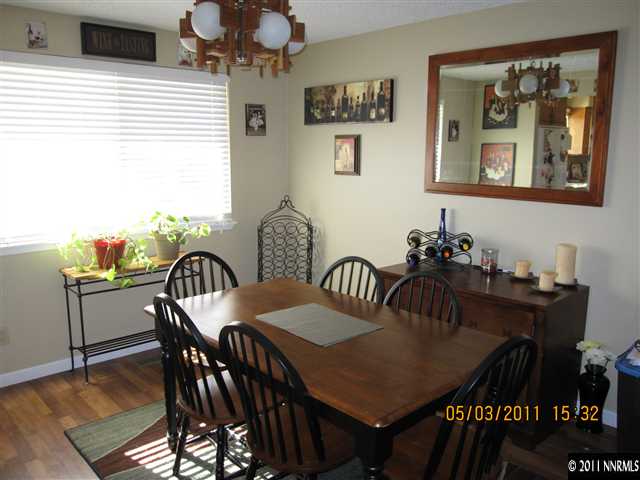 14595 Geronimo Trail Reno, NV 89521 - Photo 5 of 13 a view of a dining room with furniture and wooden floor