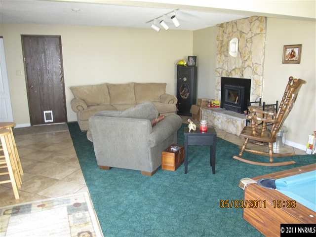 14595 Geronimo Trail Reno, NV 89521 - Photo 7 of 13 a living room with furniture and a fireplace