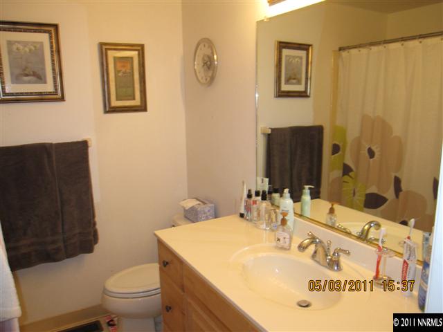 14595 Geronimo Trail Reno, NV 89521 - Photo 10 of 13 a bathroom with a sink a toilet and mirror