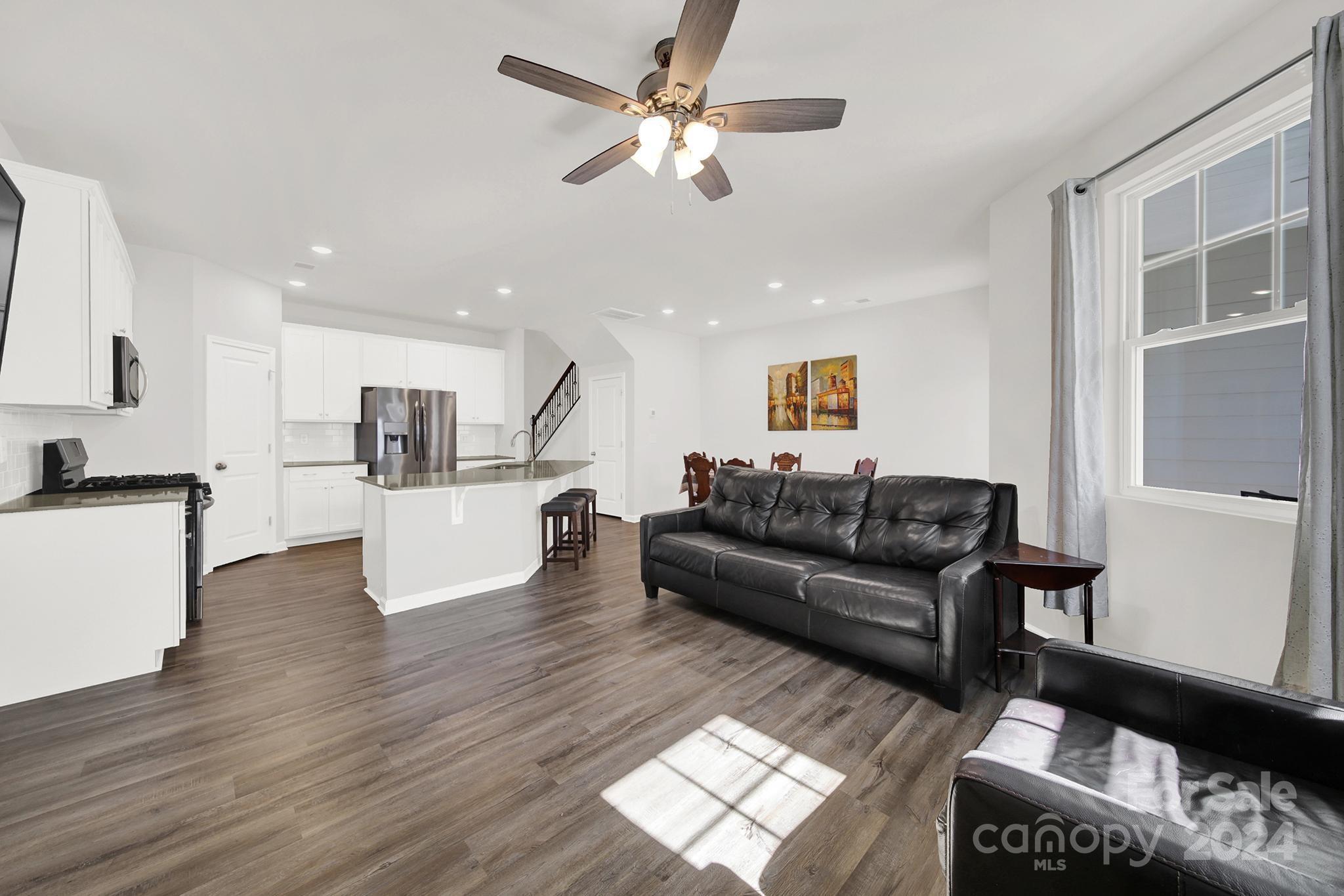 1639 Corwin Bend Road Tega Cay, SC 29708 - Photo 12 of 47 a living room with furniture and kitchen view with wooden floor