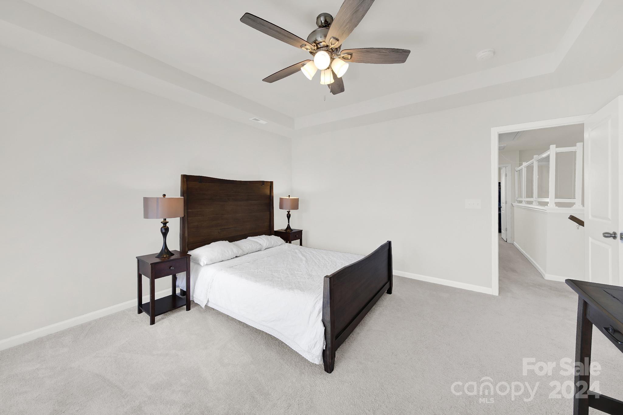 1639 Corwin Bend Road Tega Cay, SC 29708 - Photo 17 of 47 a bedroom with a bed and a ceiling fan