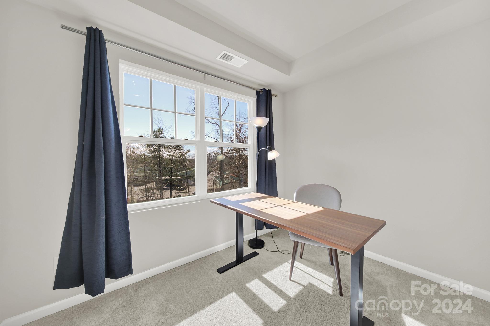 1639 Corwin Bend Road Tega Cay, SC 29708 - Photo 18 of 47 a view of a workspace with furniture and a window