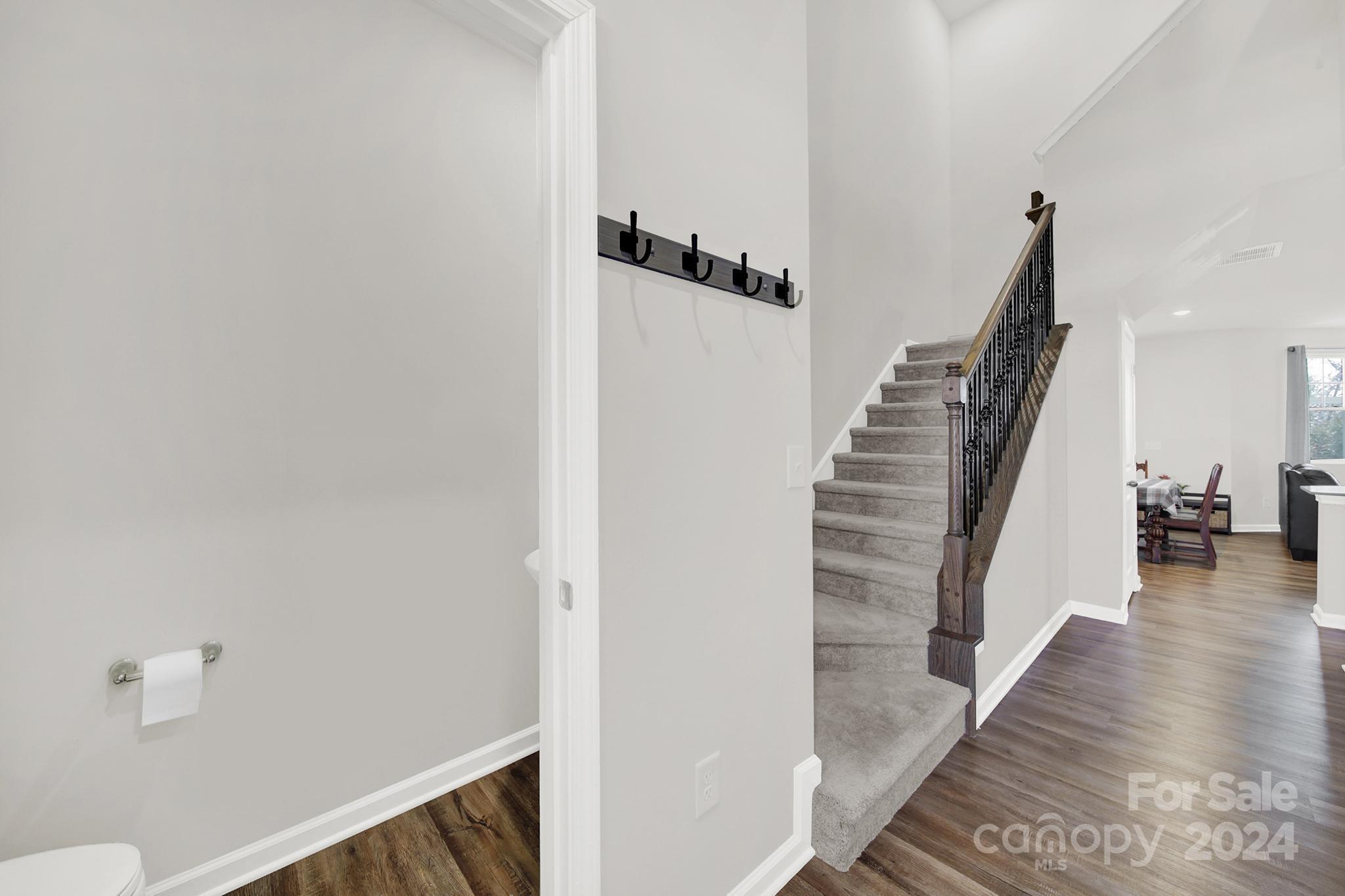 1639 Corwin Bend Road Tega Cay, SC 29708 - Photo 5 of 47 a view of a hallway with wooden floor and stairs