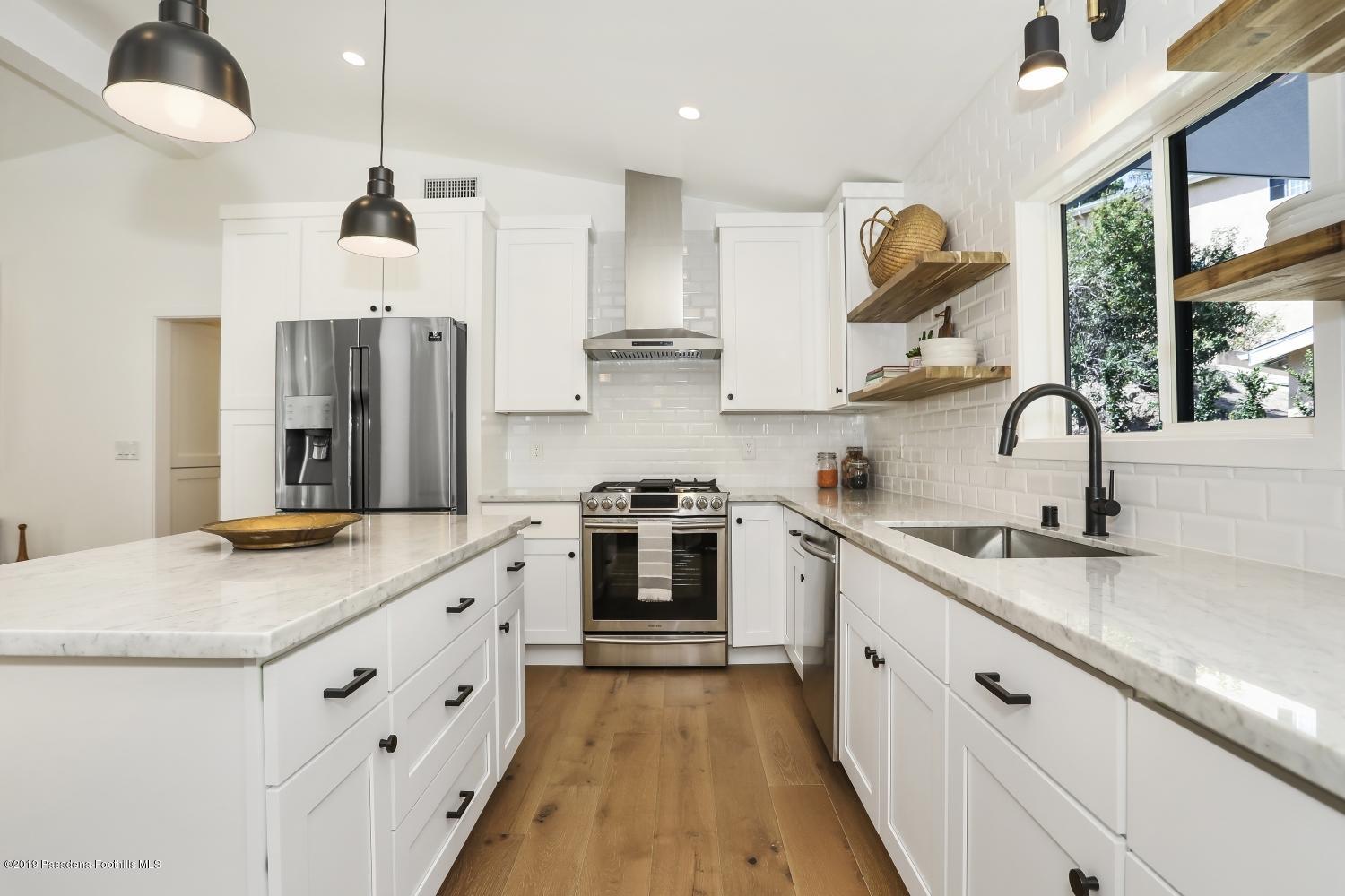 4817 Lockhaven Avenue Los Angeles, CA 90041 - Photo 14 of 34 a kitchen with granite countertop a sink stove and refrigerator