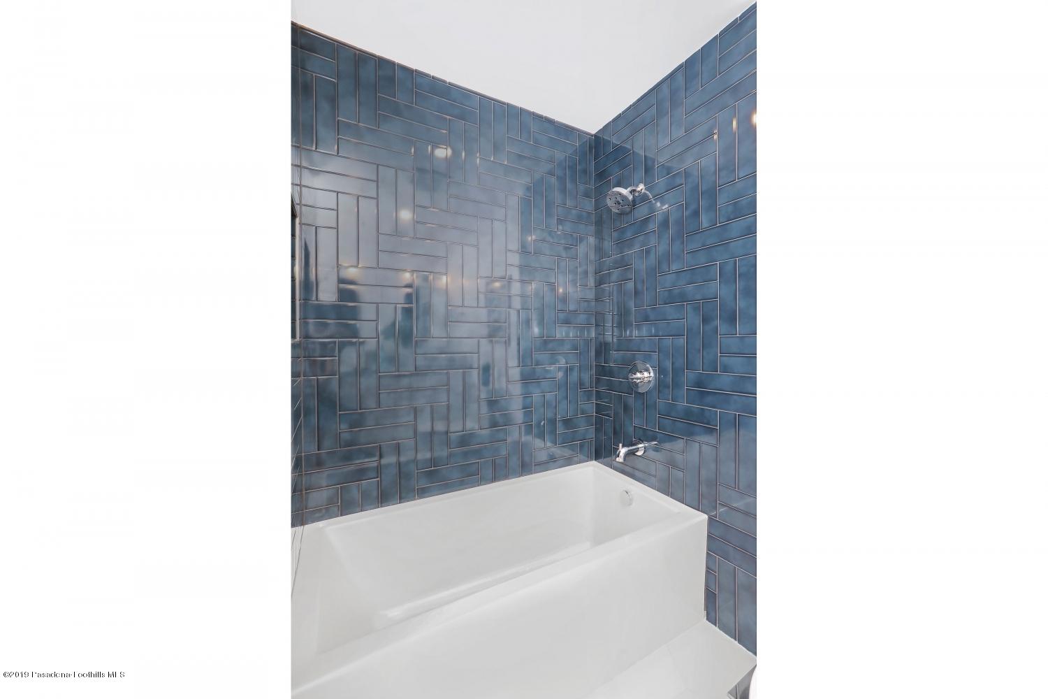 4817 Lockhaven Avenue Los Angeles, CA 90041 - Photo 24 of 34 a bathroom with a bathtub and a sink