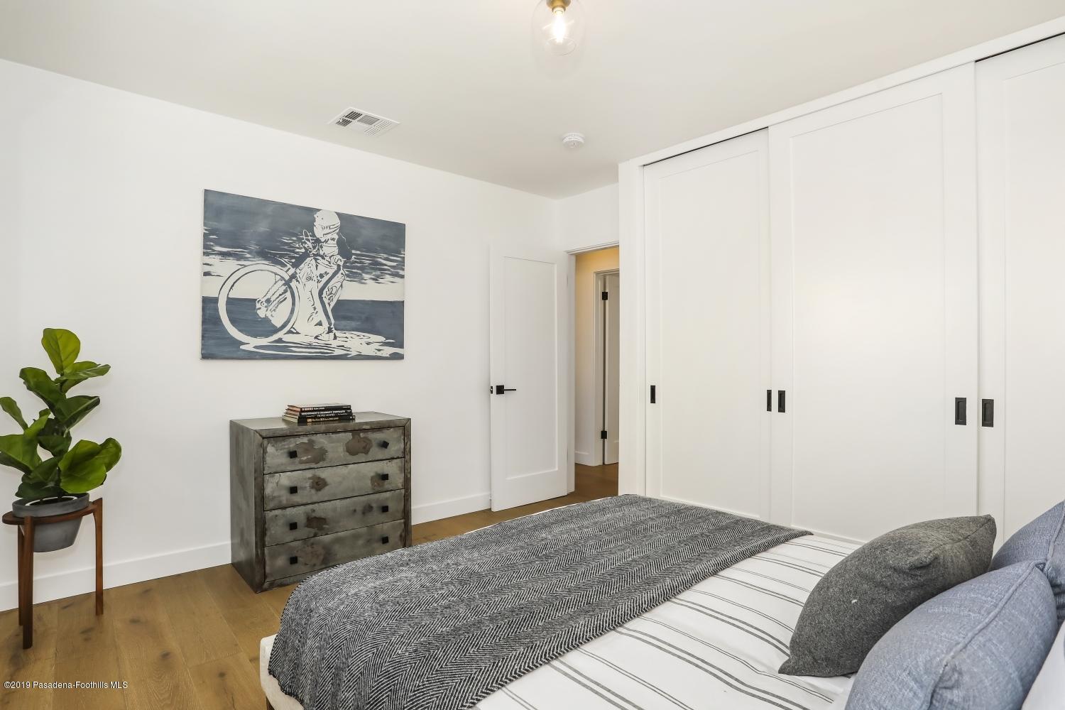 4817 Lockhaven Avenue Los Angeles, CA 90041 - Photo 25 of 34 a bedroom with a bed and a chair