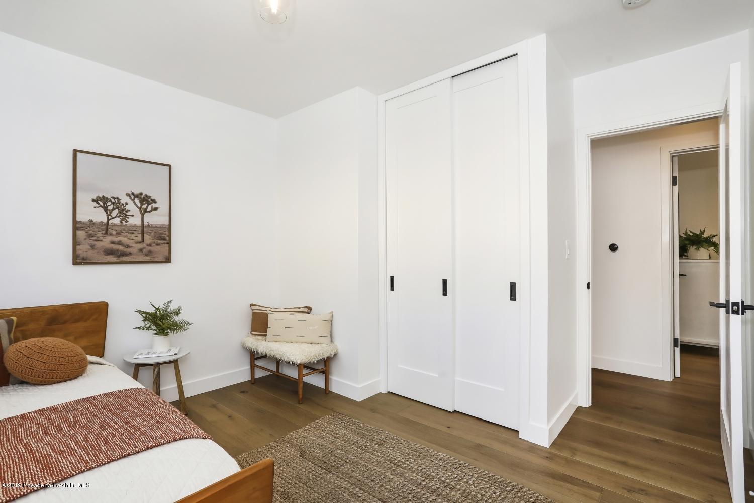 4817 Lockhaven Avenue Los Angeles, CA 90041 - Photo 27 of 34 a living room with furniture and wooden floor