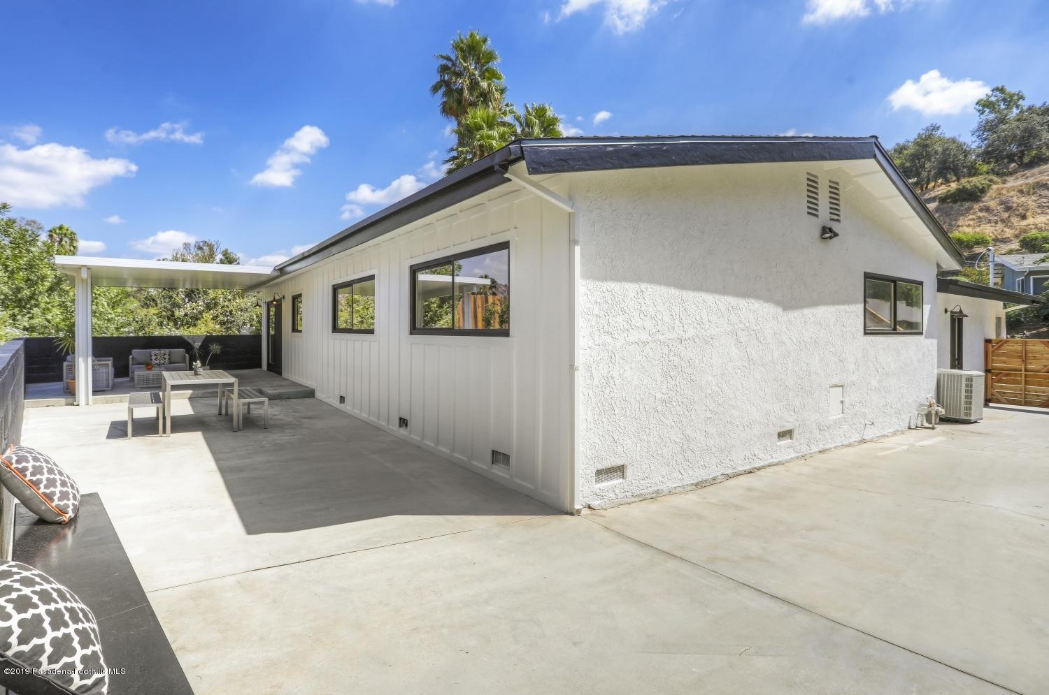 4817 Lockhaven Avenue Los Angeles, CA 90041 - Photo 33 of 34 a view of a patio with couches and table with potted plants