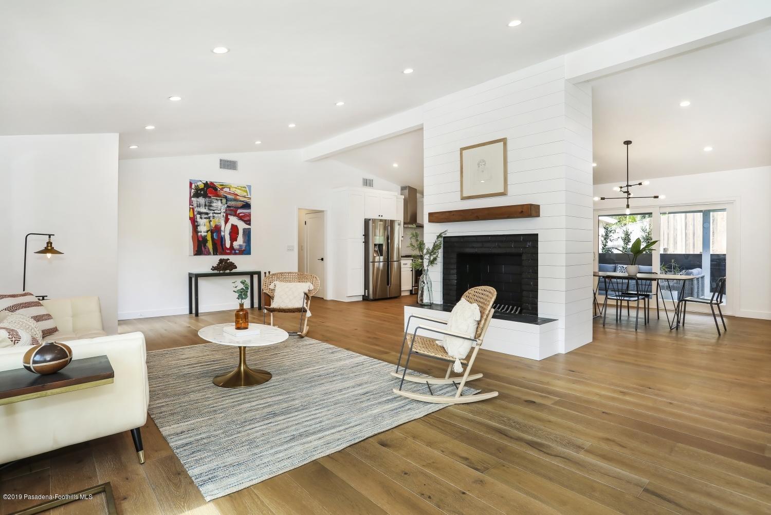 4817 Lockhaven Avenue Los Angeles, CA 90041 - Photo 7 of 34 a living room with fireplace furniture and a wooden floor