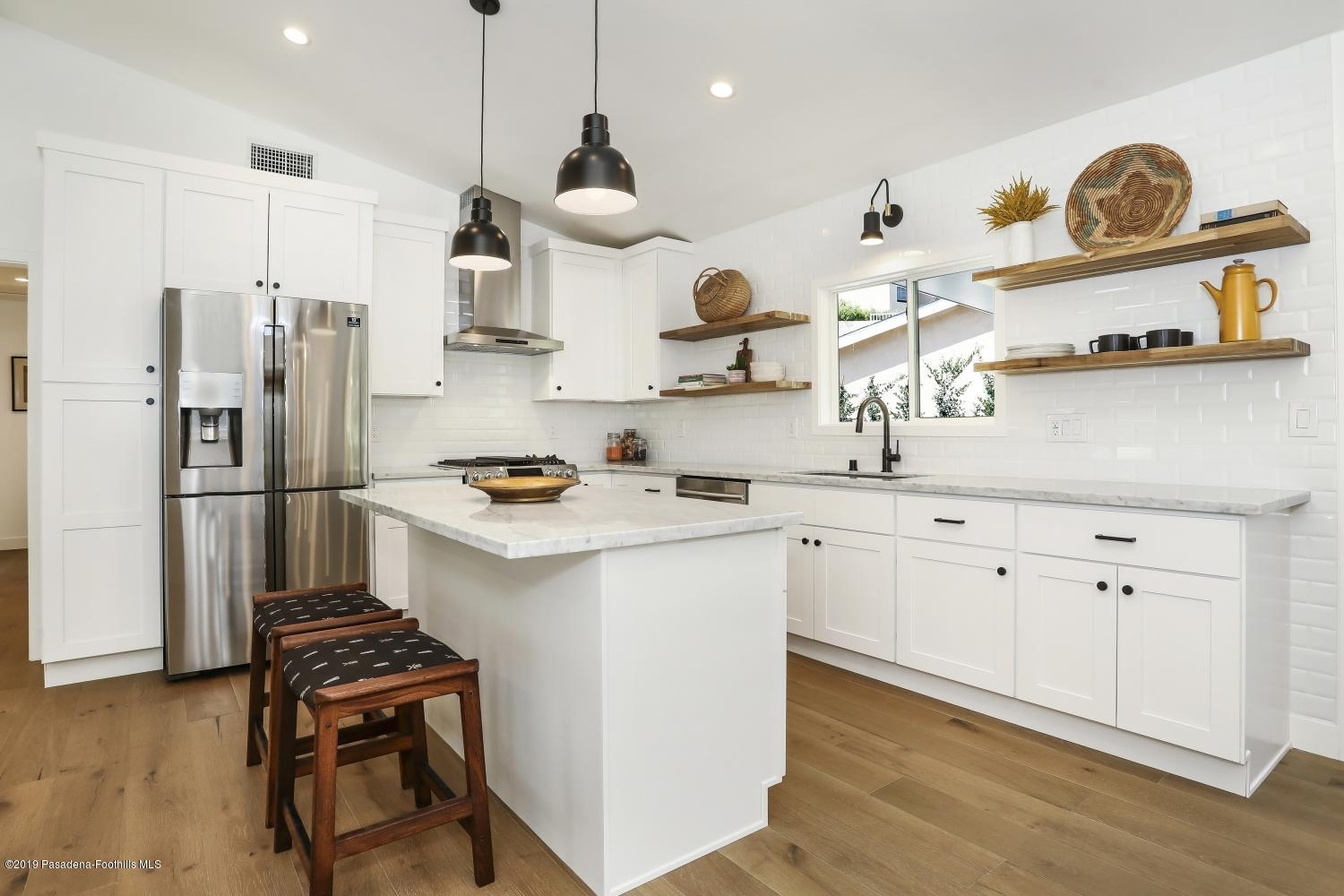 4817 Lockhaven Avenue Los Angeles, CA 90041 - Photo 10 of 34 a kitchen with stainless steel appliances granite countertop a sink stove and refrigerator