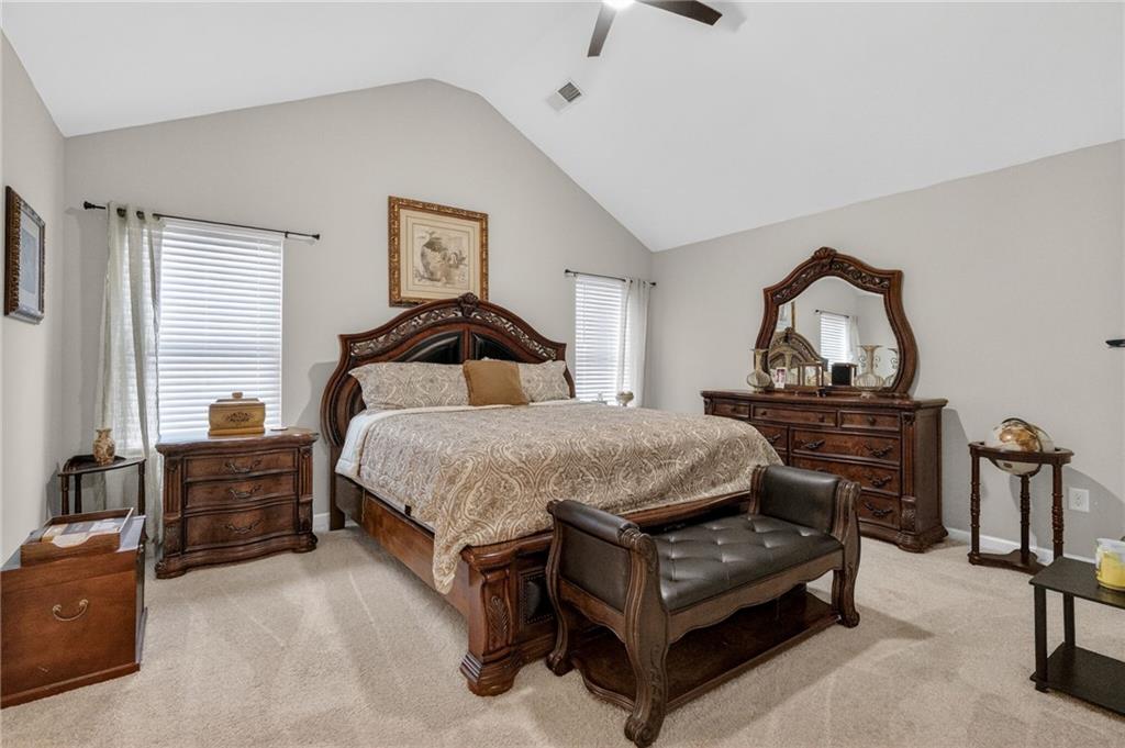 353 Daffodil Drive Temple, GA 30179 - Photo 16 of 30 a bedroom with a bed and dresser with mirror