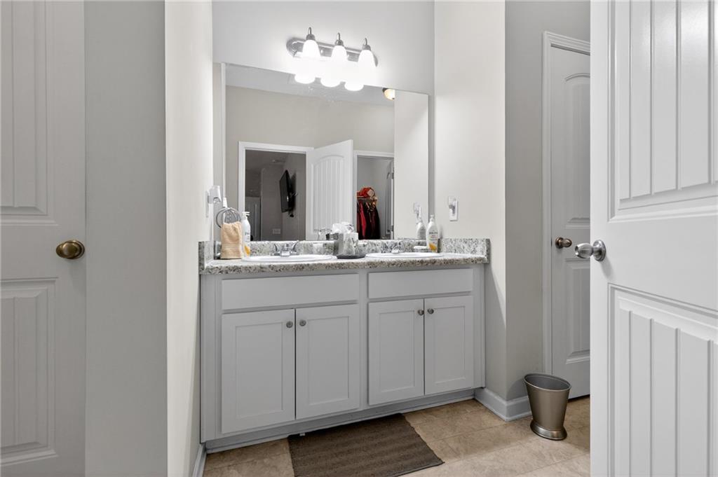 353 Daffodil Drive Temple, GA 30179 - Photo 21 of 30 a bathroom with a double vanity sink and a mirror